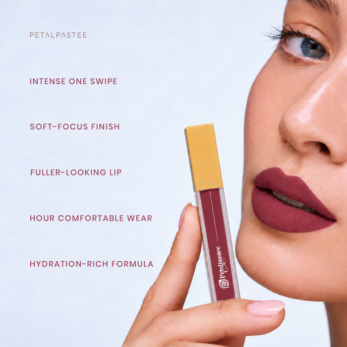 Model holding Crimson Luxe Plum Royal: intense one swipe, soft-focus finish, fuller-looking lip, comfortable wear, hydration-rich formula